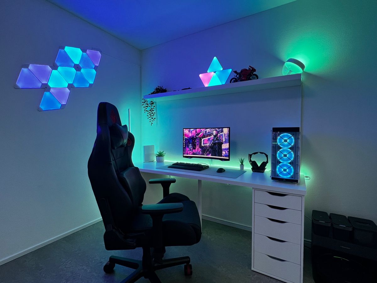 Team reviewing games around a large monitor